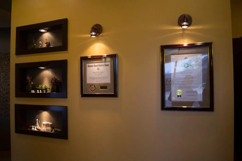 Wall displaying Dr. Dele’s credentials and awards