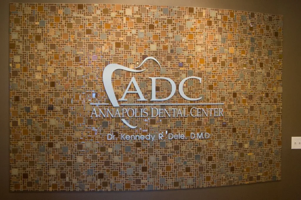 Reception feature wall with the brushed-metal Annapolis Dental Center sign