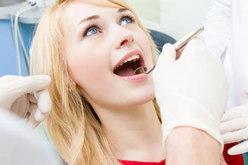 Dental hygienist polishing a patient's smile